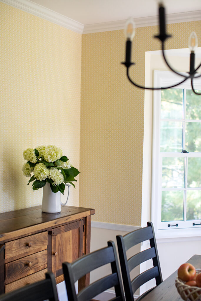 A dining room designed by Jackie Barnes Design. A vintage credenza adds warmth and charm to the space.